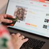 Engaging in online shopping using a credit card with a laptop for convenience and ease.